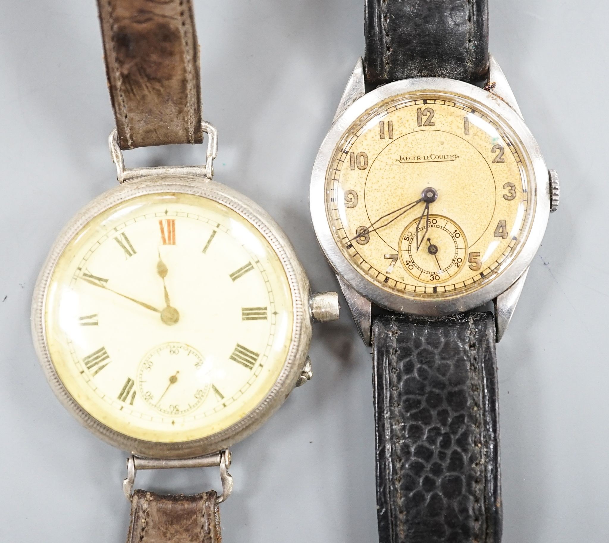 A gentleman's stainless steel Jaeger LeCoultre manual wind wrist watch, case back numbered 64765, on associated strap and a white metal fob watch, now mounted as a wrist watch(a.f.).